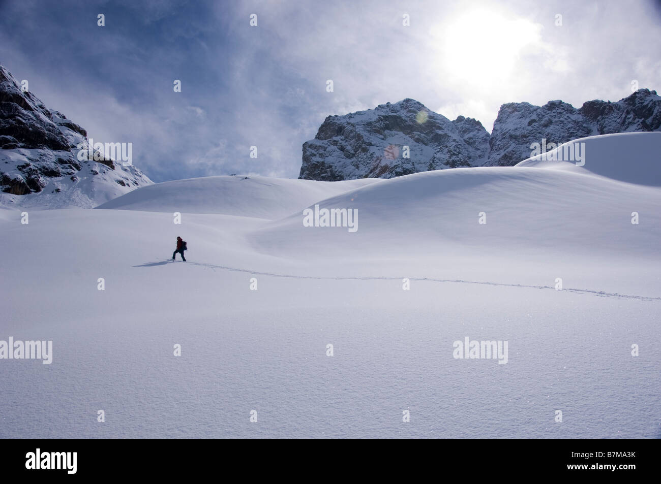 Ski alpinist making a track in `Valletta dal Guglia` near the Julier Pass, Swiss Alps, Graubunden. Stock Photo